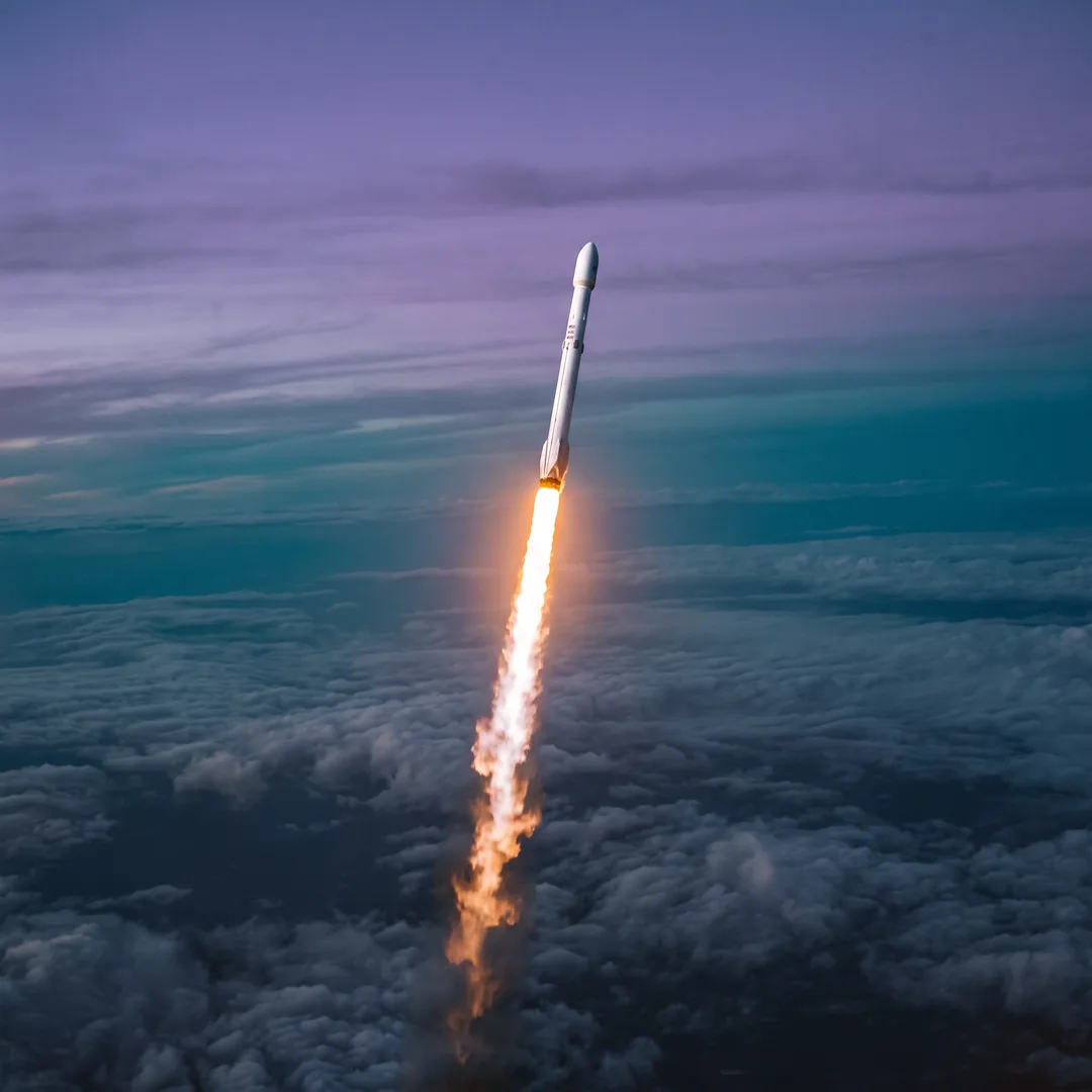 A rocket lifting off at dusk — performance taking off
